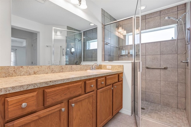 full bathroom featuring a stall shower, vanity, and tile patterned floors