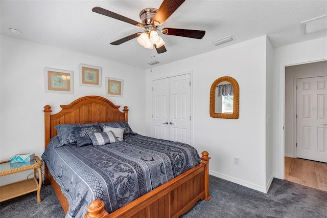 bedroom featuring a ceiling fan, visible vents, baseboards, a closet, and carpet