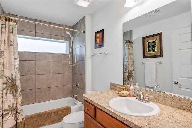 bathroom featuring toilet, vanity, visible vents, and shower / tub combo with curtain