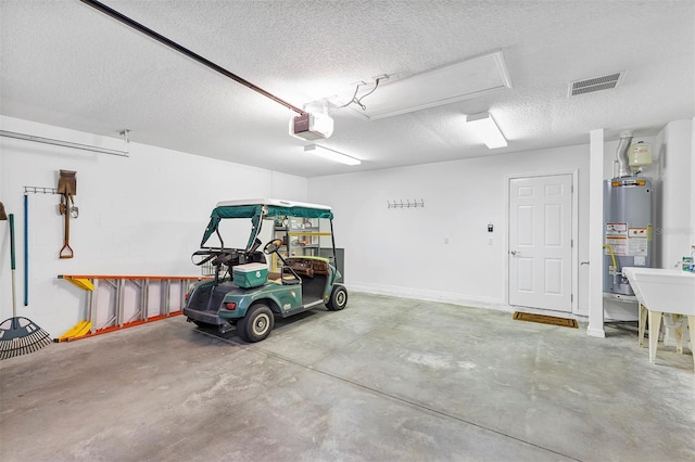 garage with gas water heater, visible vents, and a garage door opener