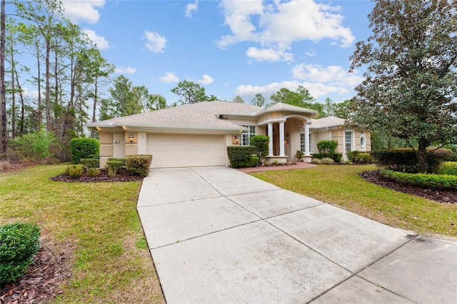 view of front of house featuring an attached garage, stucco siding, concrete driveway, and a front yard