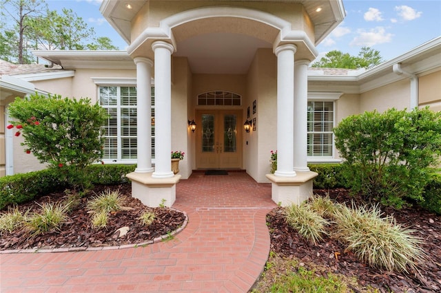 doorway to property featuring stucco siding and french doors