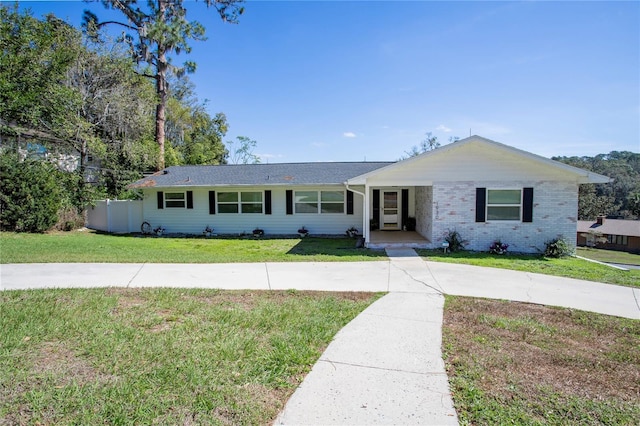 single story home with brick siding and a front lawn