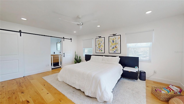 1930 Hilltop Dr, Mount Dora, FL 32757 - bedroom featuring baseboards, a barn door, light wood-type flooring, and recessed lighting
