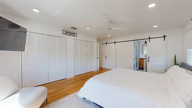 1930 Hilltop Dr, Mount Dora, FL 32757 - bedroom featuring a barn door, visible vents, a ceiling fan, light wood-style flooring, and recessed lighting