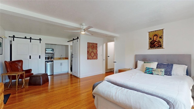 1930 Hilltop Dr, Mount Dora, FL 32757 - bedroom featuring light wood-style flooring, a barn door, ceiling fan, baseboards, and fridge