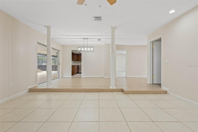 unfurnished room with a ceiling fan, visible vents, decorative columns, and light tile patterned floors