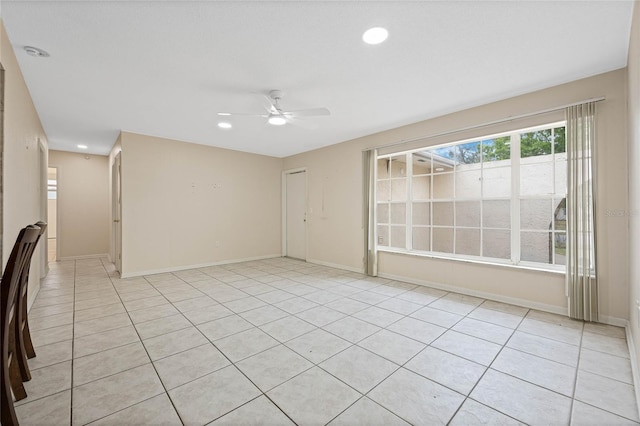 unfurnished room with a ceiling fan, recessed lighting, light tile patterned flooring, and baseboards