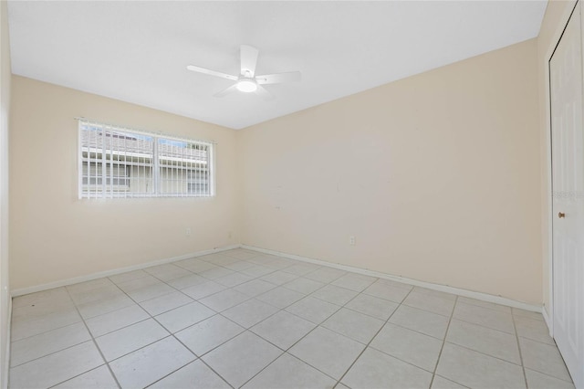 empty room featuring ceiling fan and baseboards