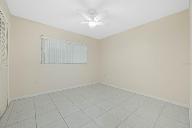 unfurnished room with a ceiling fan and baseboards