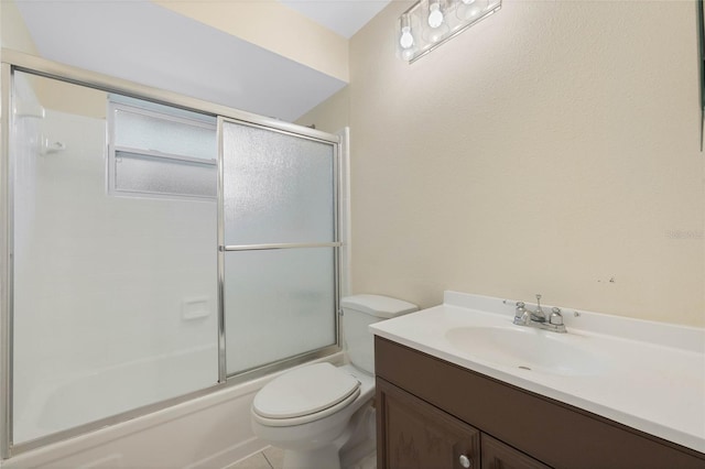 bathroom with enclosed tub / shower combo, vanity, and toilet