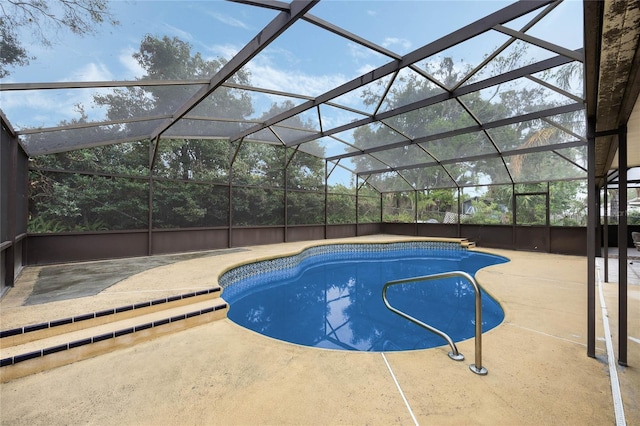 pool with a lanai and a patio area