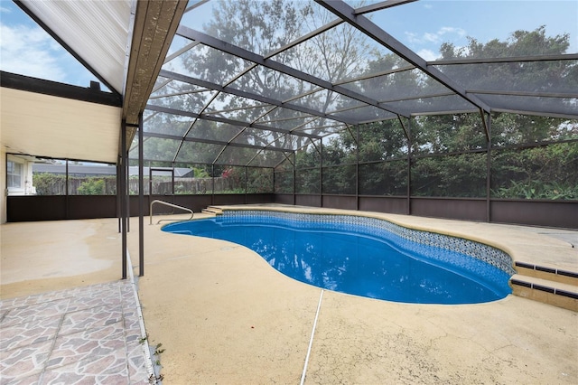 pool featuring glass enclosure and a patio area