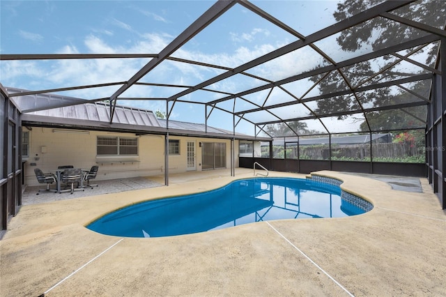 view of pool with a fenced in pool, glass enclosure, and a patio