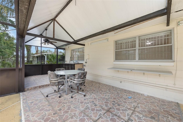 sunroom featuring lofted ceiling with beams and a ceiling fan