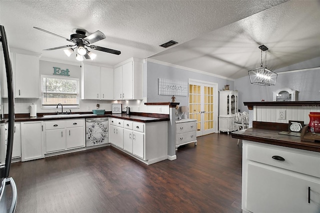 kitchen featuring dark wood-type flooring, a sink, white cabinets, stainless steel dishwasher, and crown molding