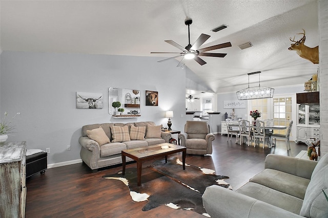 living room with lofted ceiling, visible vents, wood finished floors, and ceiling fan with notable chandelier