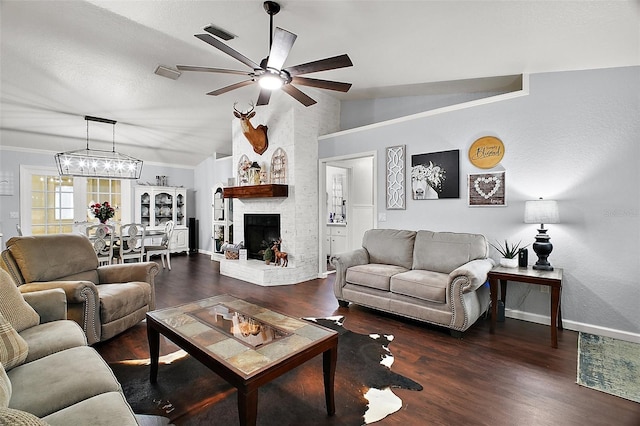 living room featuring ceiling fan, wood finished floors, baseboards, vaulted ceiling, and a brick fireplace