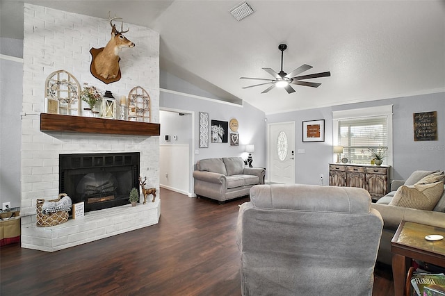 living area featuring visible vents, a ceiling fan, lofted ceiling, wood finished floors, and a fireplace