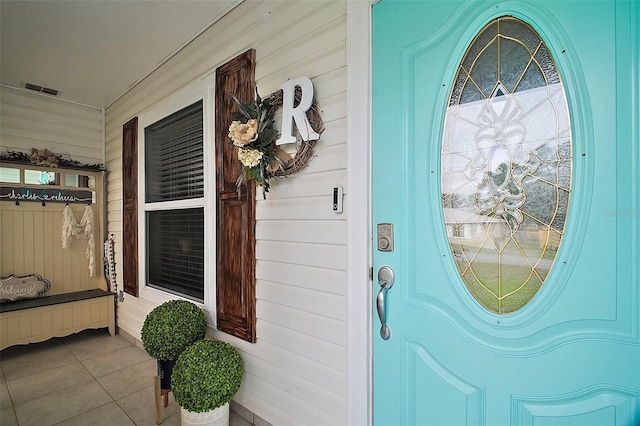 property entrance featuring covered porch and visible vents