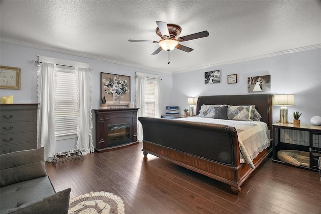 bedroom featuring a textured ceiling, ceiling fan, dark wood-style flooring, and crown molding