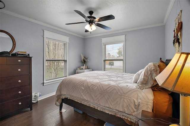 bedroom featuring dark wood-style floors, ornamental molding, a textured ceiling, and baseboards