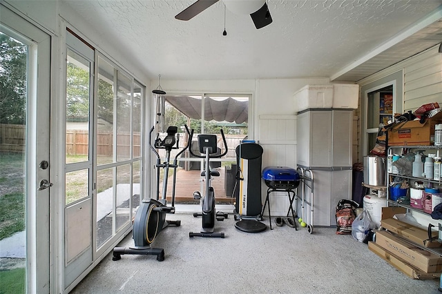 exercise room featuring a textured ceiling and a ceiling fan