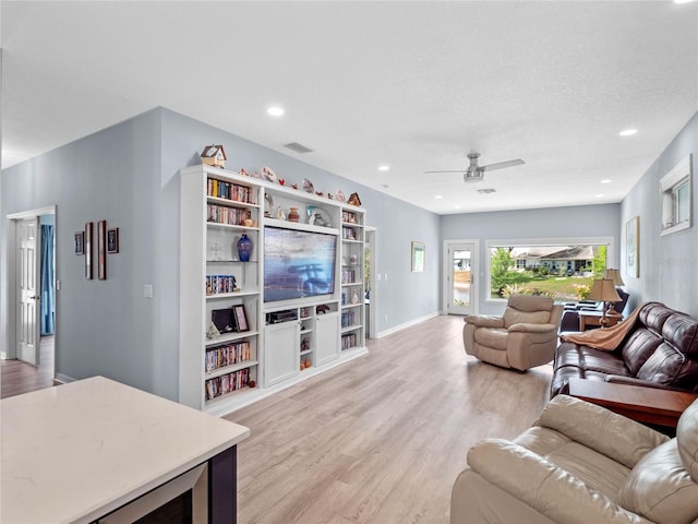 living area with recessed lighting, visible vents, light wood-style flooring, ceiling fan, and baseboards