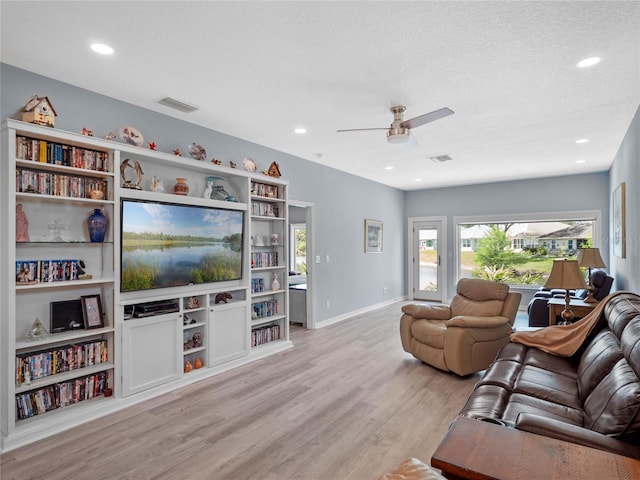 living area with light wood-style flooring, recessed lighting, visible vents, and baseboards