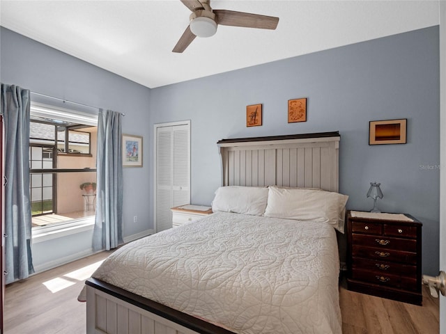 bedroom featuring ceiling fan, a closet, and light wood-type flooring