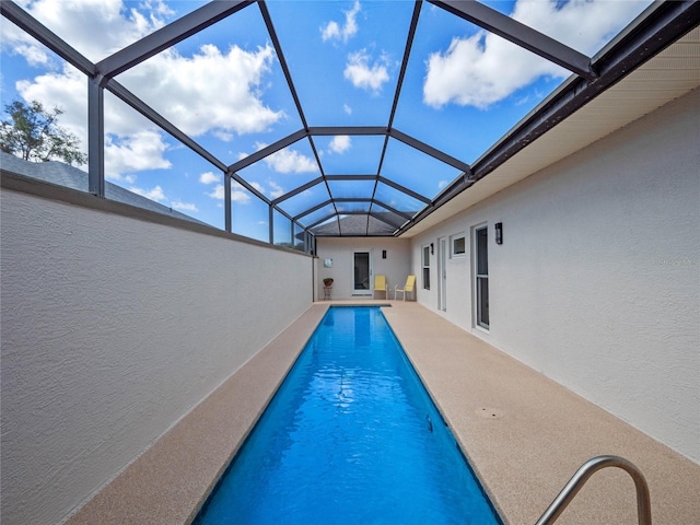 outdoor pool featuring a patio area and a lanai