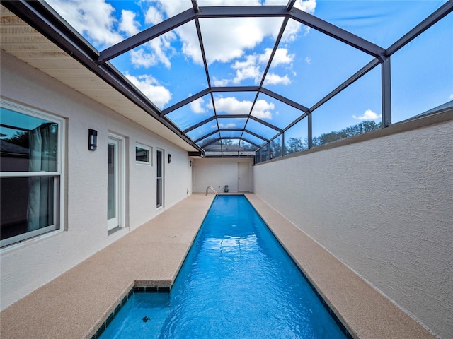 outdoor pool with a patio and a lanai