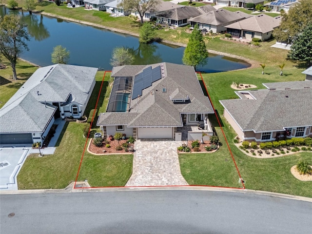 drone / aerial view featuring a residential view and a water view