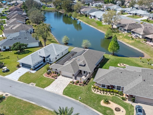 drone / aerial view featuring a water view and a residential view