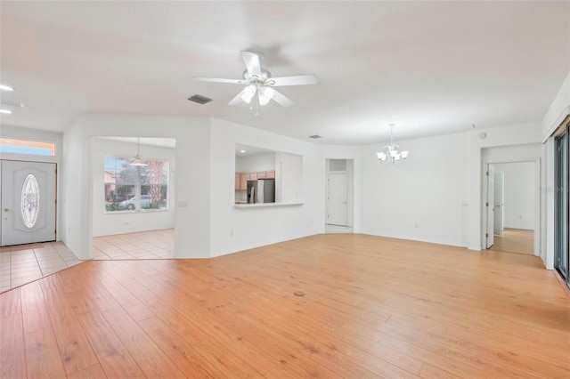 unfurnished living room with light wood-style flooring, visible vents, and ceiling fan with notable chandelier