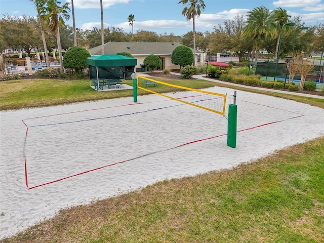 view of home's community featuring a yard and volleyball court