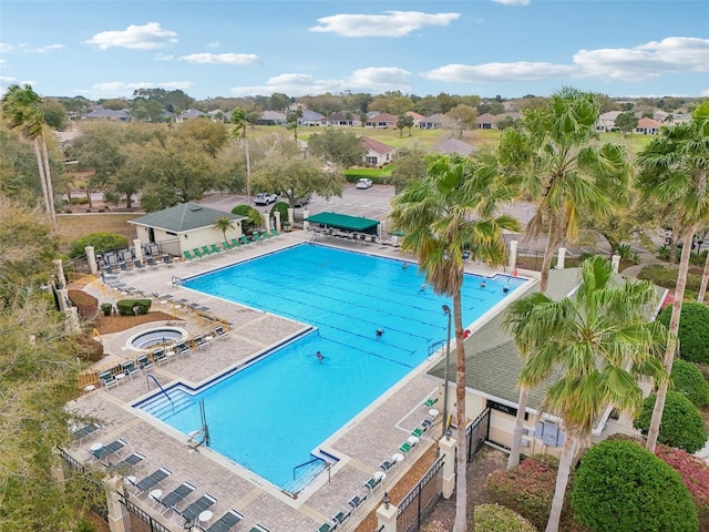 pool with a patio area and fence