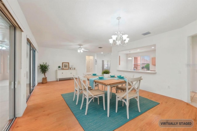 dining room with light wood-style floors, recessed lighting, visible vents, and ceiling fan with notable chandelier