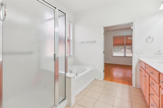 bathroom with a healthy amount of sunlight, a shower stall, vanity, and tile patterned floors