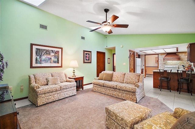 living room with high vaulted ceiling, visible vents, ceiling fan, and light tile patterned floors