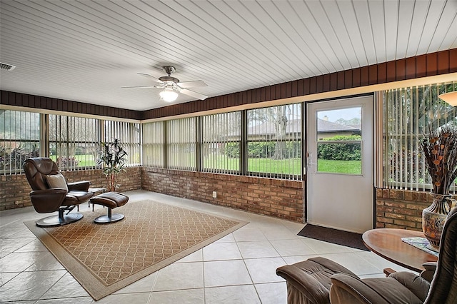 sunroom featuring a ceiling fan