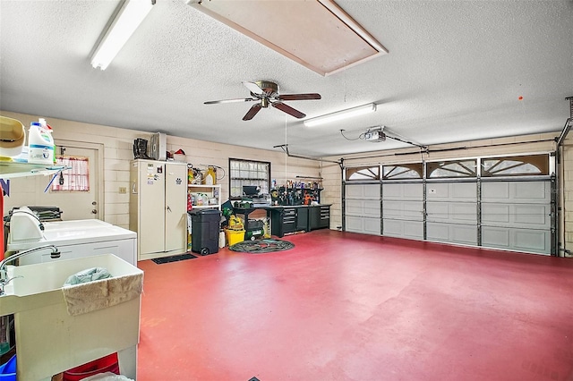 garage featuring washer / dryer, a sink, and a garage door opener