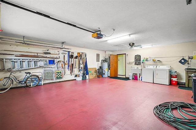 garage with gas water heater, a garage door opener, ceiling fan, washing machine and clothes dryer, and a sink