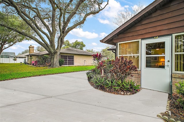 view of home's exterior with a yard, a patio, and stucco siding