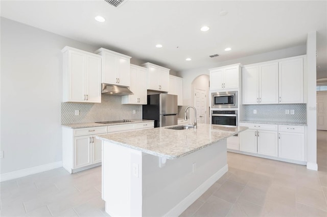 kitchen featuring stainless steel appliances, a sink, white cabinets, and under cabinet range hood