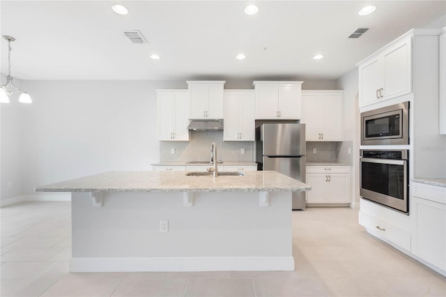 kitchen with appliances with stainless steel finishes, visible vents, a sink, and under cabinet range hood