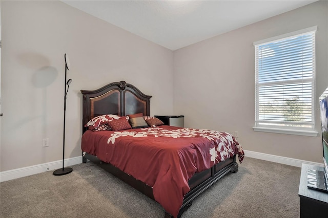 carpeted bedroom featuring baseboards