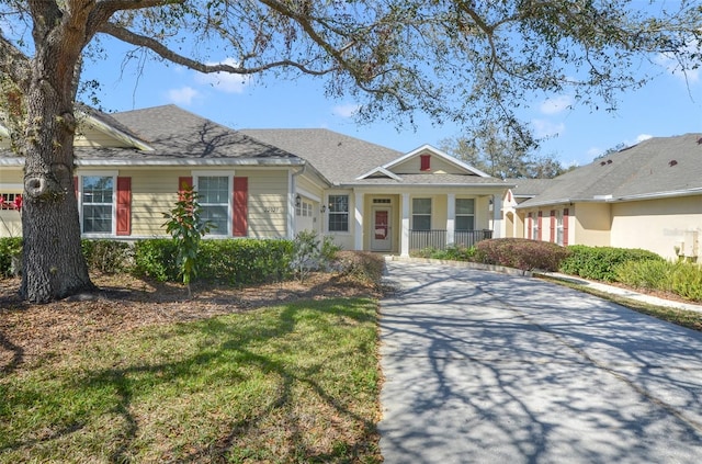 view of front of property featuring a garage and roof with shingles