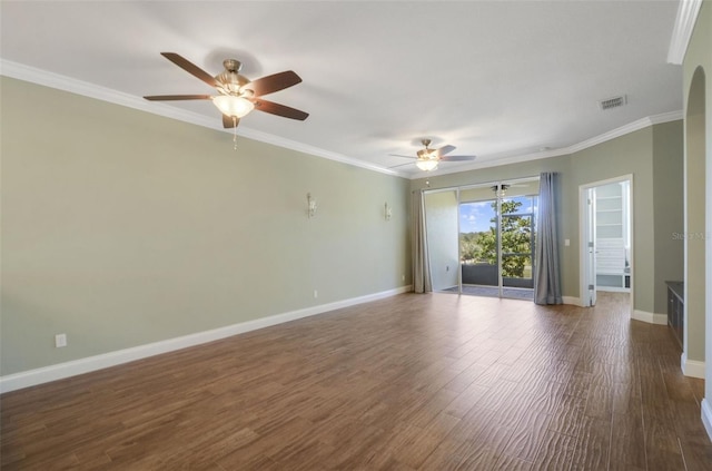 spare room featuring ornamental molding, visible vents, baseboards, and wood finished floors