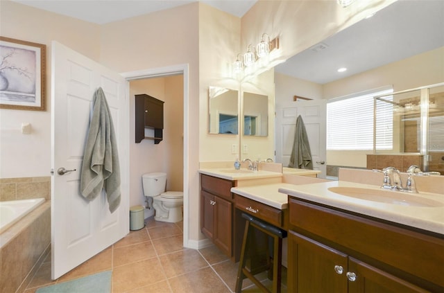 bathroom featuring a stall shower, toilet, tile patterned flooring, vanity, and a bath